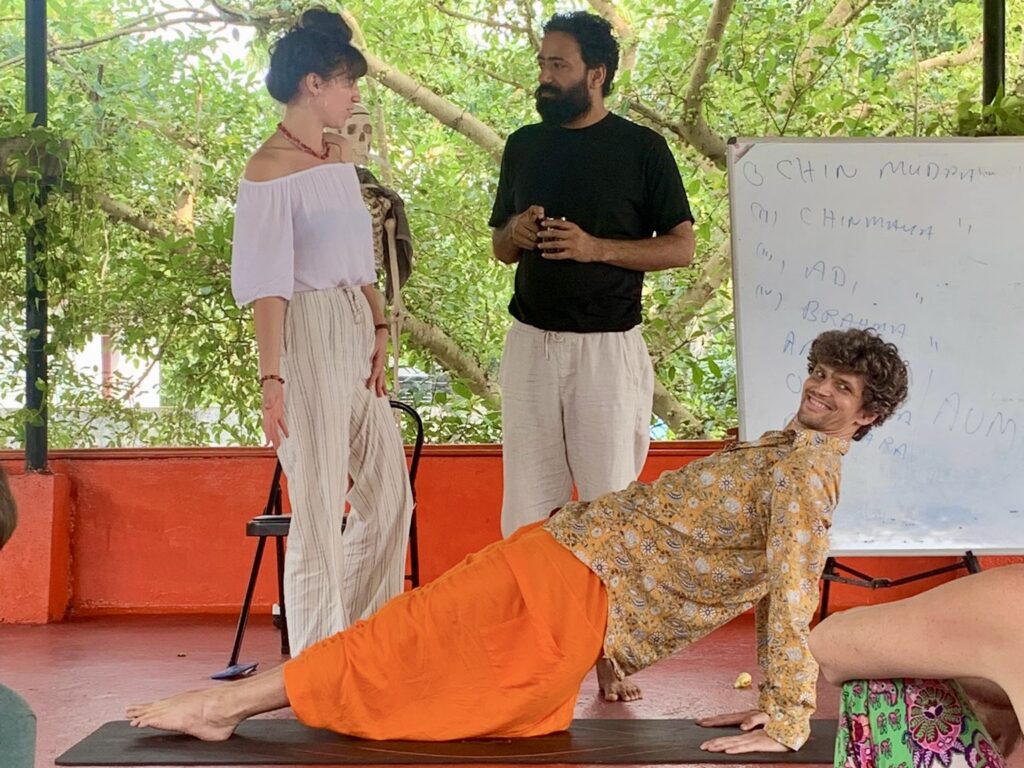 hatha-yoga-adjustment-classroom-scene-devvrat-yoga-sangha-kerala